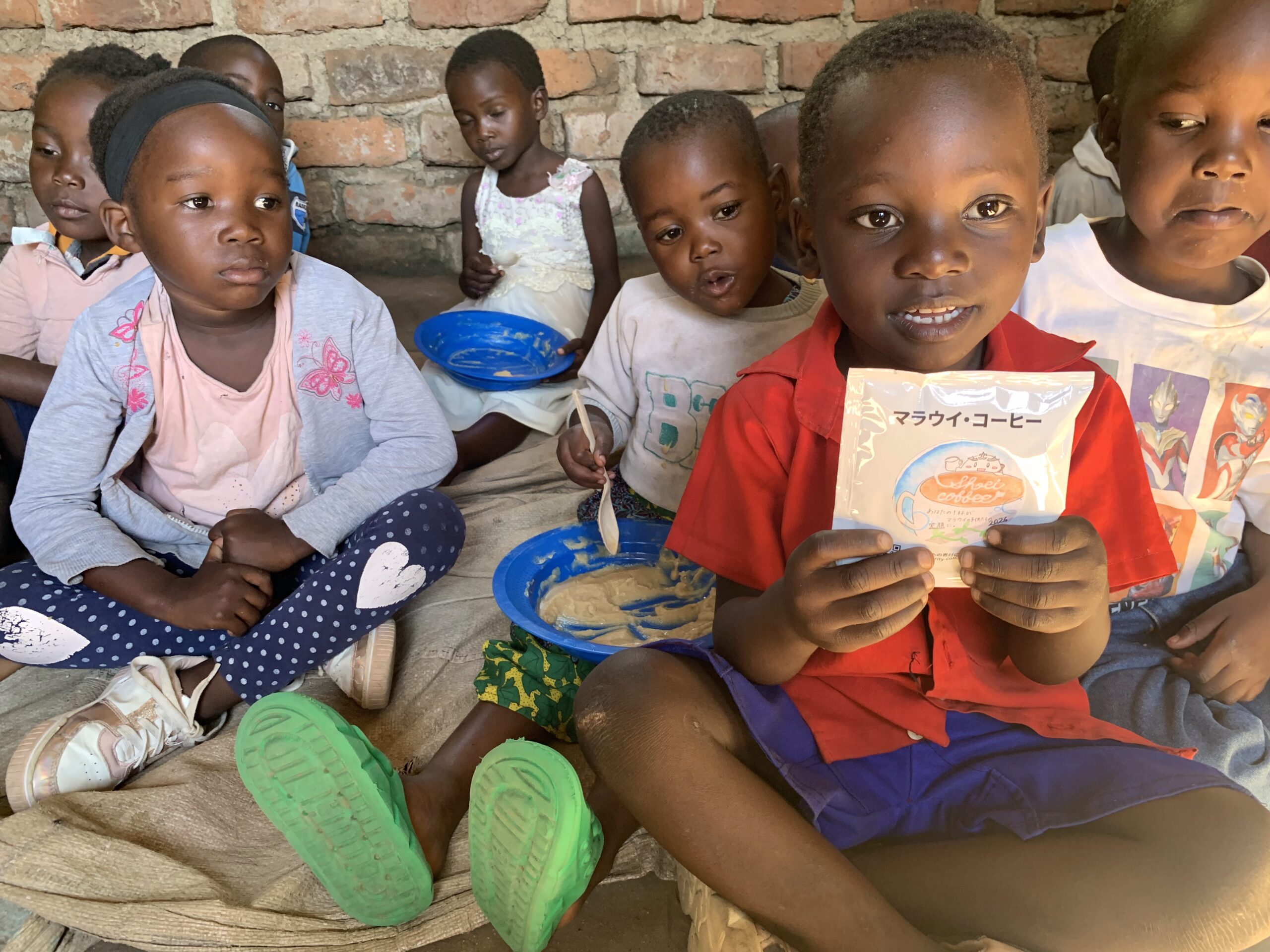Children in Malawi eating school meals